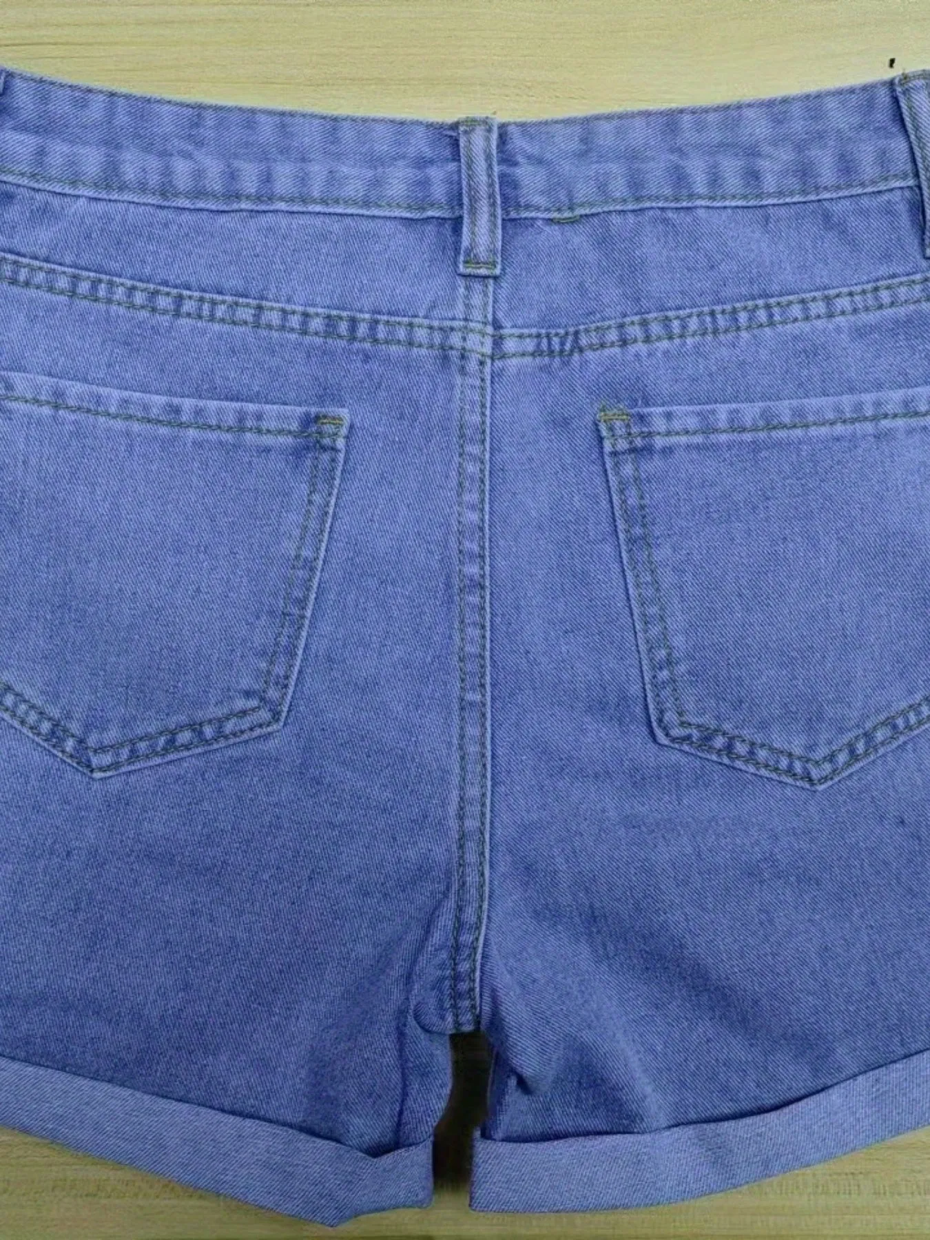 Trendy Blue Denim Shorts with Chic Ripped Details & Rolled Hem - Durable, Casual Wear for Fashion-Forward Women